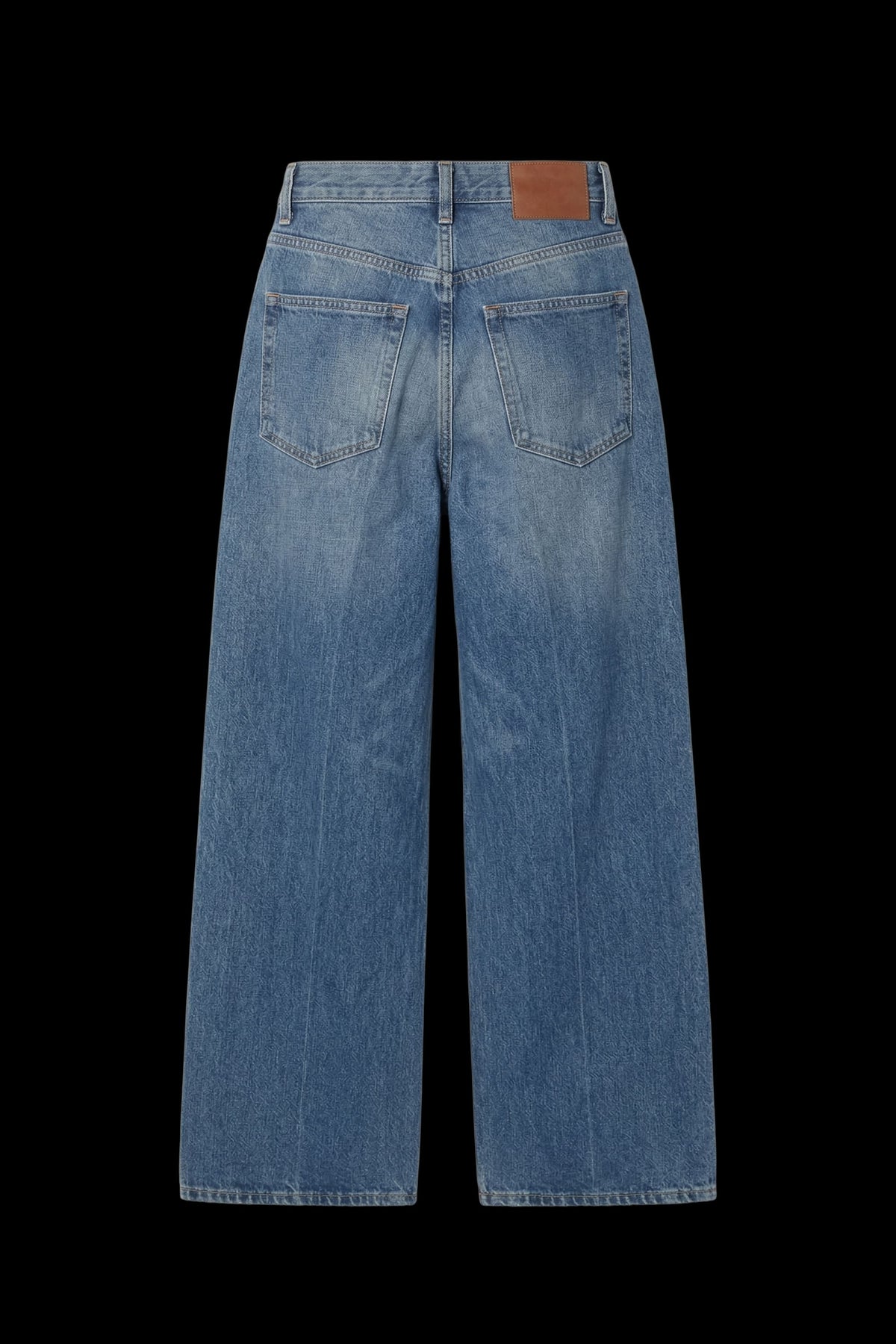 Back view of light blue wide-leg denim jeans with a brown leather patch on the waistband, displayed against a solid black background.