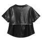 A black faux-leather cropped short-sleeve top with a layered, ruffled hem, shown from the back on a plain white background.