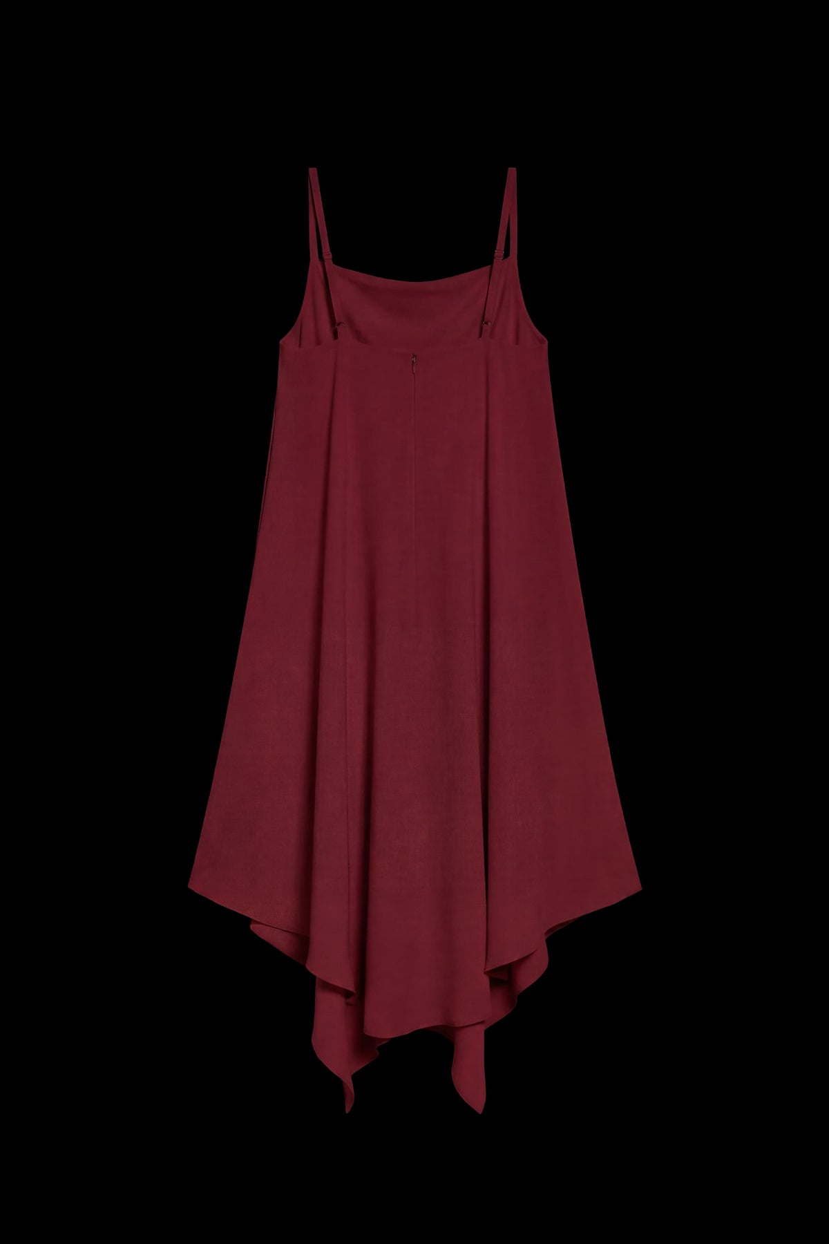 A dark red high-low slip dress with thin spaghetti straps, displayed against a solid black background.
