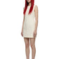 A model with long red hair and black sunglasses wearing a sleeveless cream-colored mini dress and black heels, standing against a solid white background.