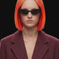 A long burgundy wool-blend coat with notch lapels, front closure, and side pockets, shown against a solid black background.
