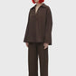 A dark brown long-sleeve collared blouse with a split V-neckline, displayed on a clean white background.