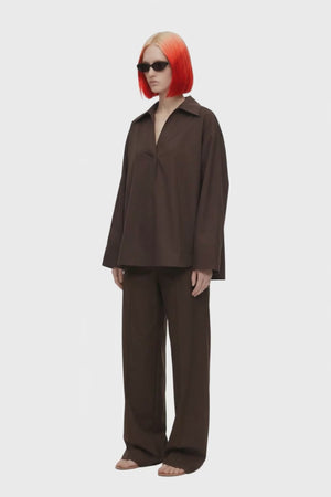 A dark brown long-sleeve collared blouse with a split V-neckline, displayed on a clean white background.