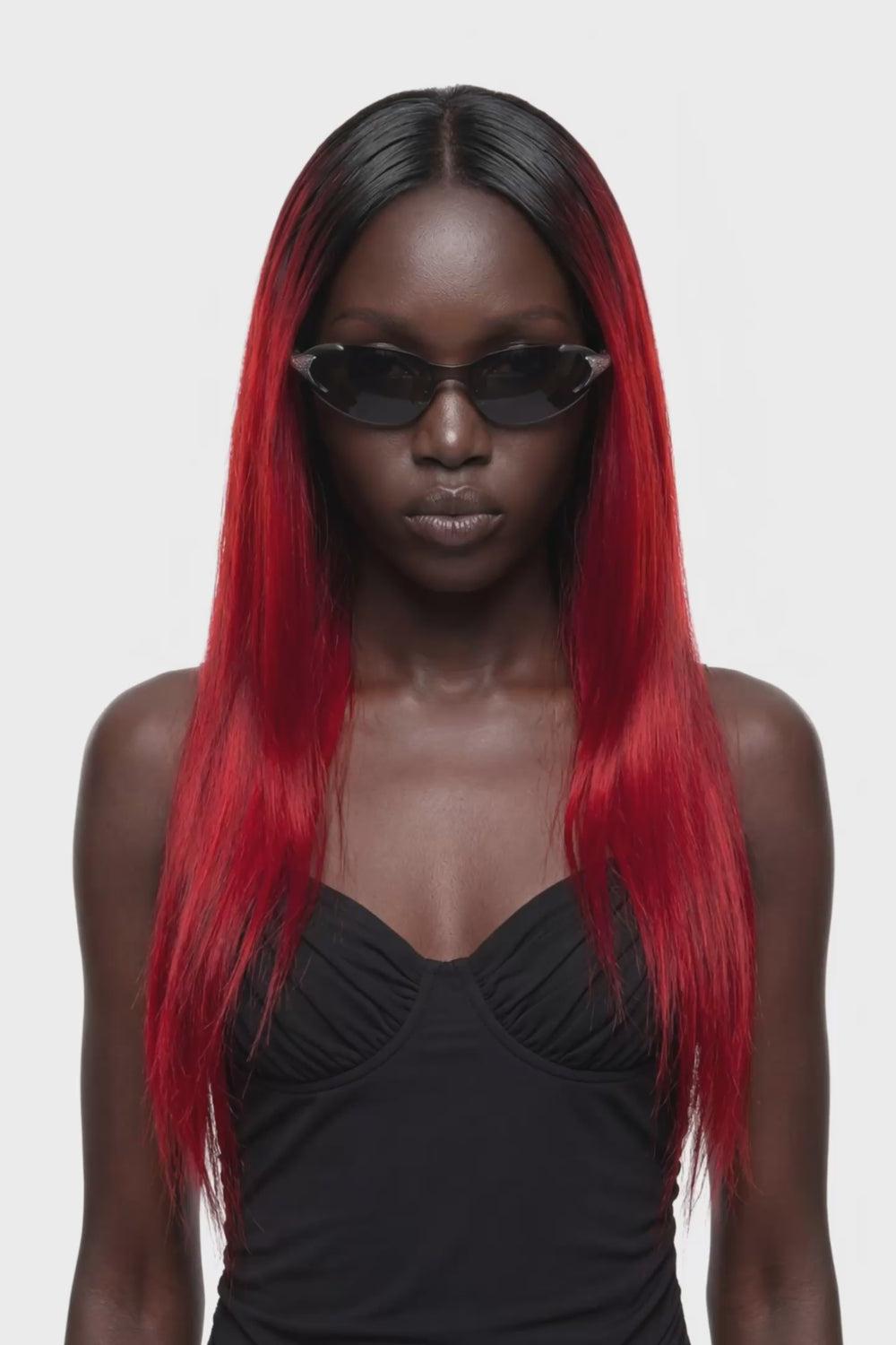 A black sleeveless maxi dress with thin spaghetti straps, a sweetheart neckline, and a draped, gathered silhouette, shown against a plain white background.