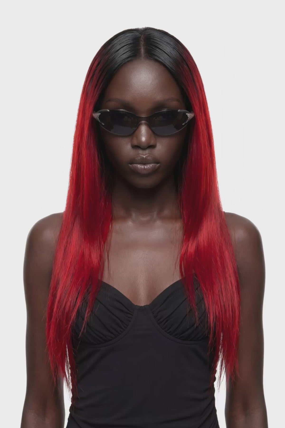 A black sleeveless maxi dress with thin spaghetti straps, a sweetheart neckline, and a draped, gathered silhouette, shown against a plain white background.