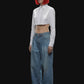 Light blue wide-leg denim jeans with a high waist and front pleats, shown flat against a solid black background.