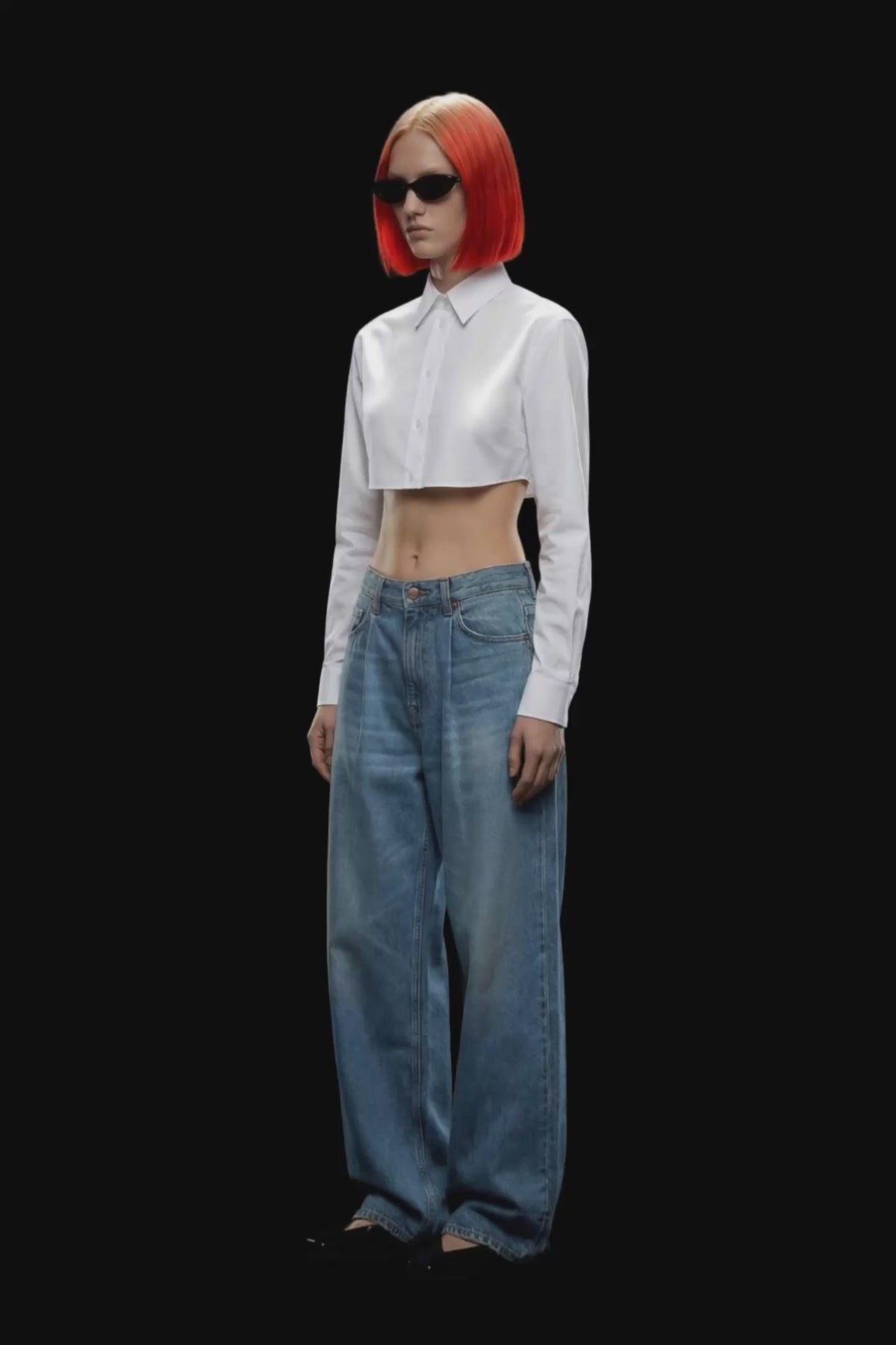 Light blue wide-leg denim jeans with a high waist and front pleats, shown flat against a solid black background.