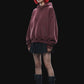 A dark burgundy pullover hoodie with a front kangaroo pocket and subtle tonal side details, displayed against a solid black background.
