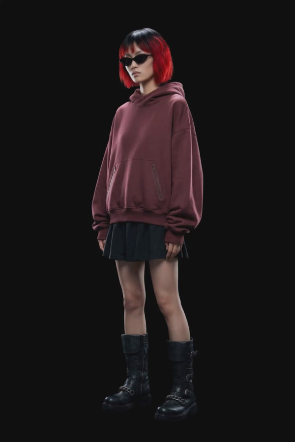 A dark burgundy pullover hoodie with a front kangaroo pocket and subtle tonal side details, displayed against a solid black background.