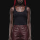 A pair of dark reddish-brown faux leather cropped pants with a wide leg, shown against a solid black 