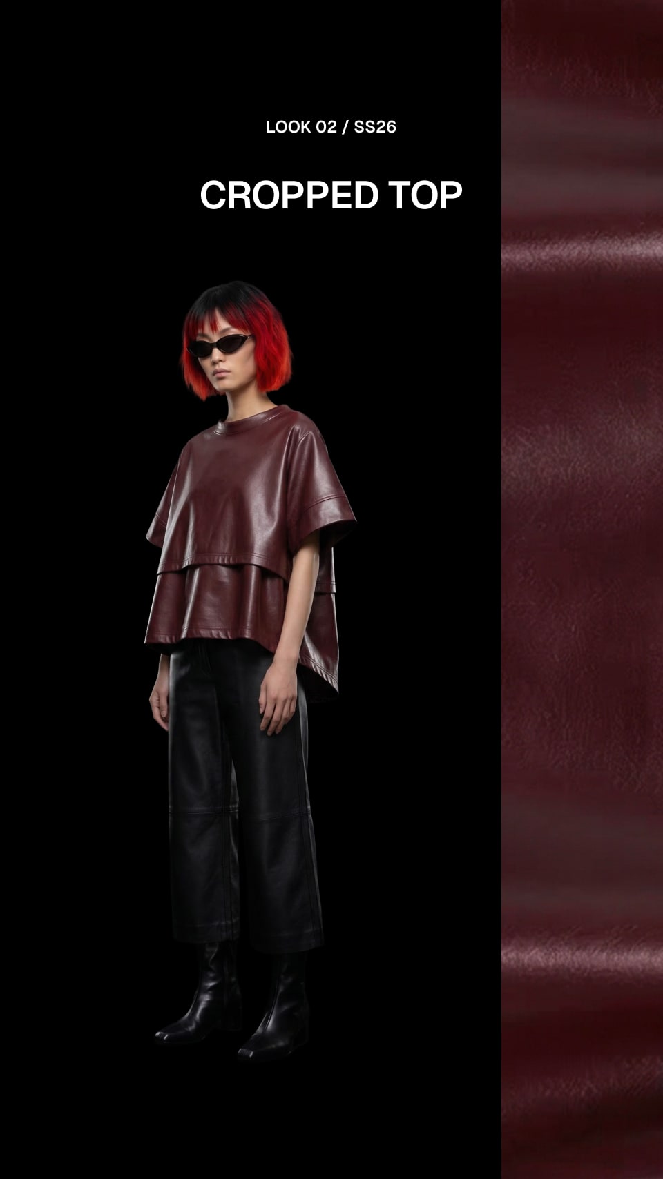 A model with bright red hair and sunglasses wears a dark burgundy cropped top with draped sleeves and black pants against a black background, with a burgundy fabric texture panel on the right and text reading 'LOOK 02 / S526' and 'CROPPED TOP'.